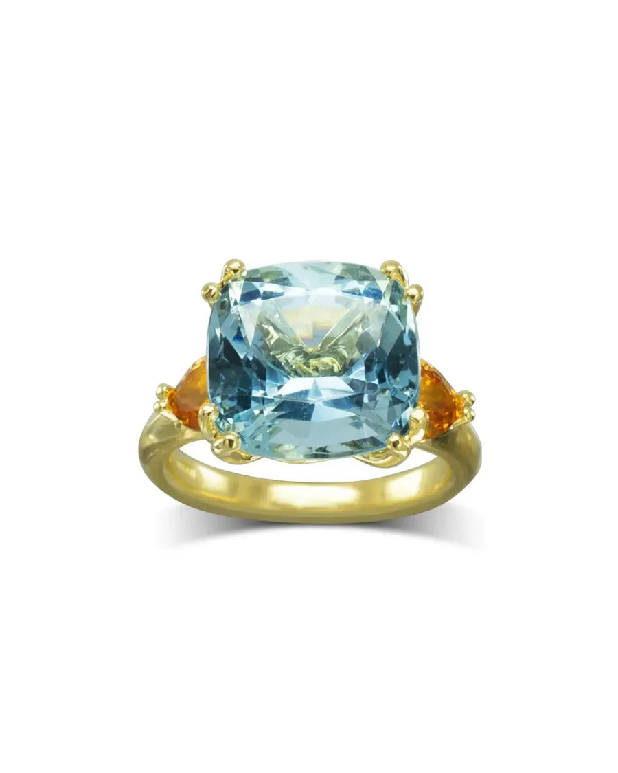Gold dress ring with a cushion-cut aquamarine and two trillion-cut orange sapphires.