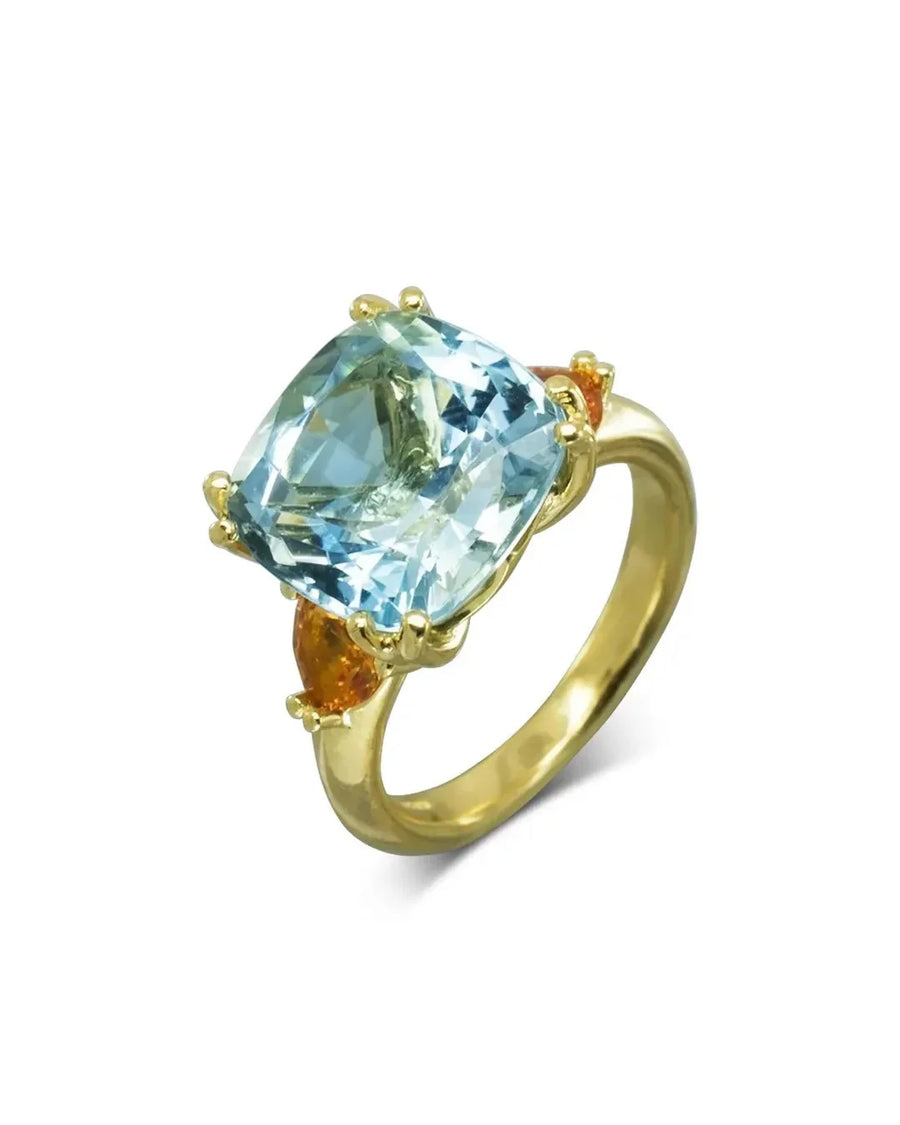 Gold dress ring with a cushion-cut aquamarine and two orange sapphires.