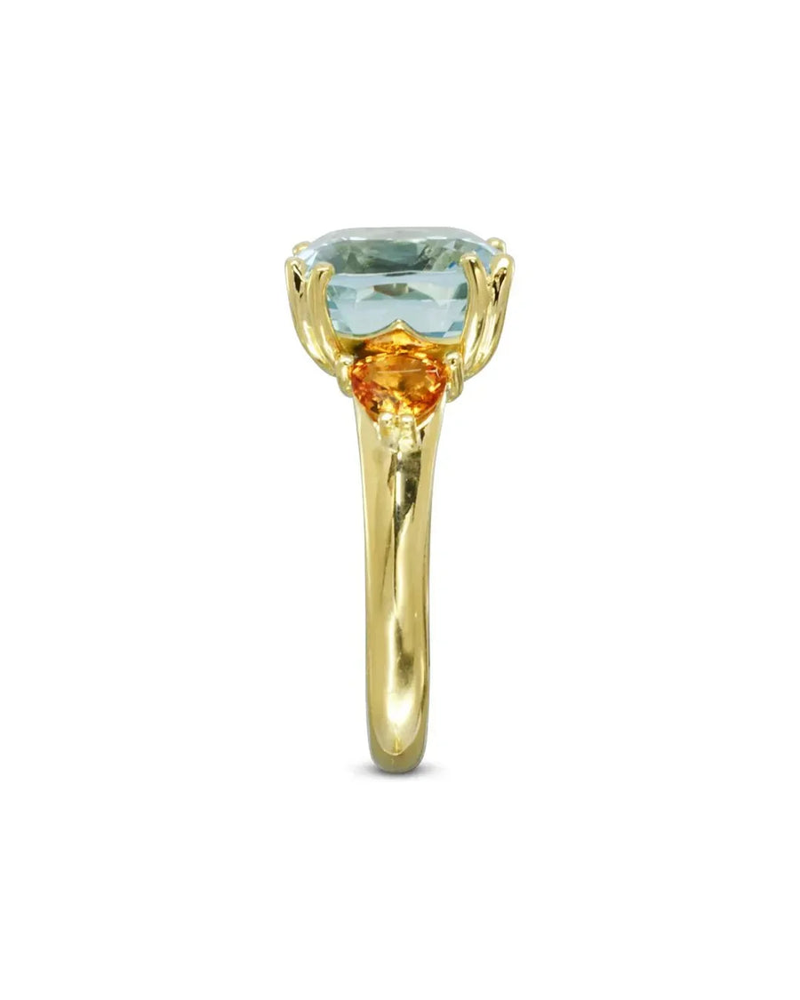 Gold dress ring with an aquamarine and two orange sapphires.
