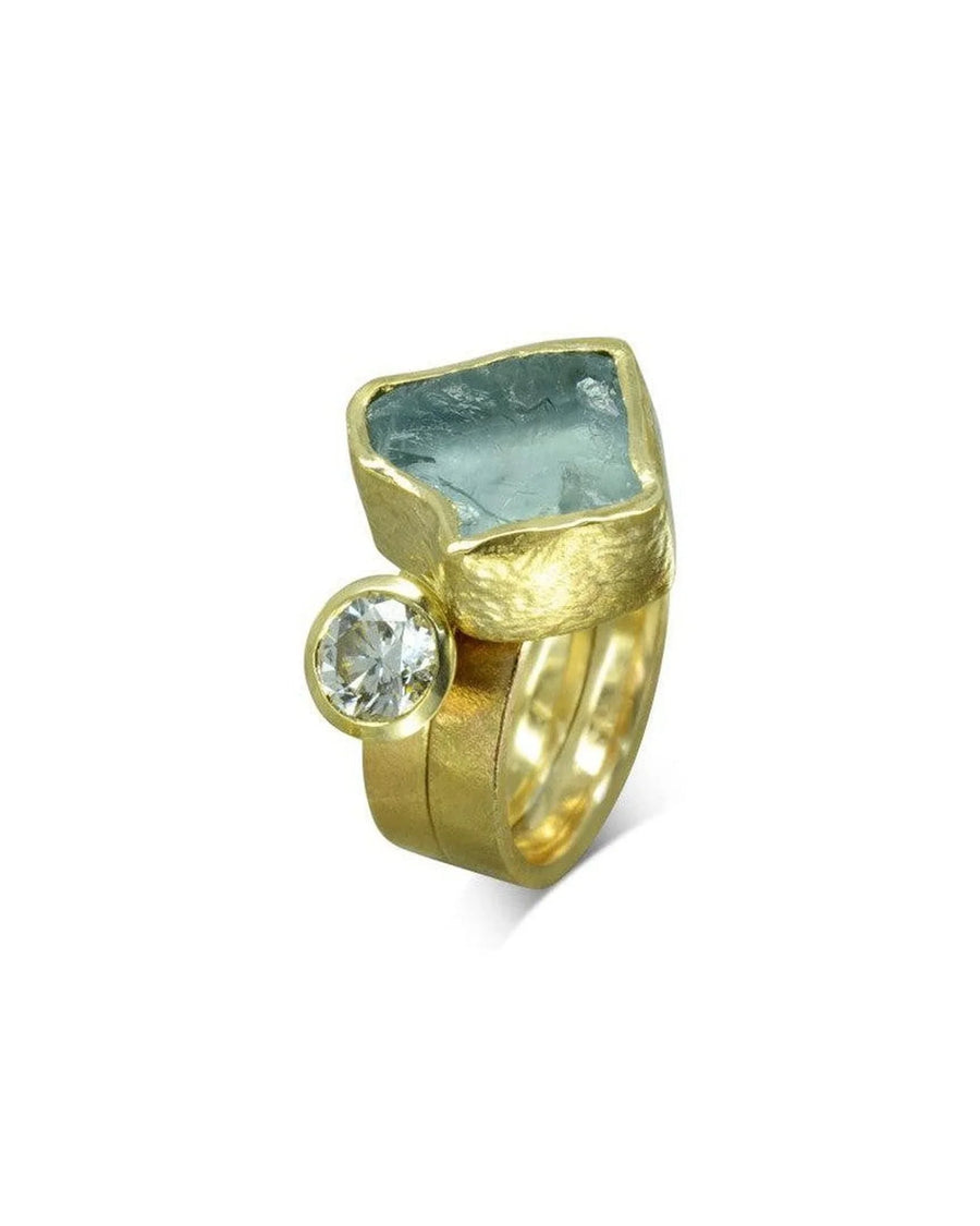 Gold stacking ring set with raw aquamarine chunk and round diamond, organic texture