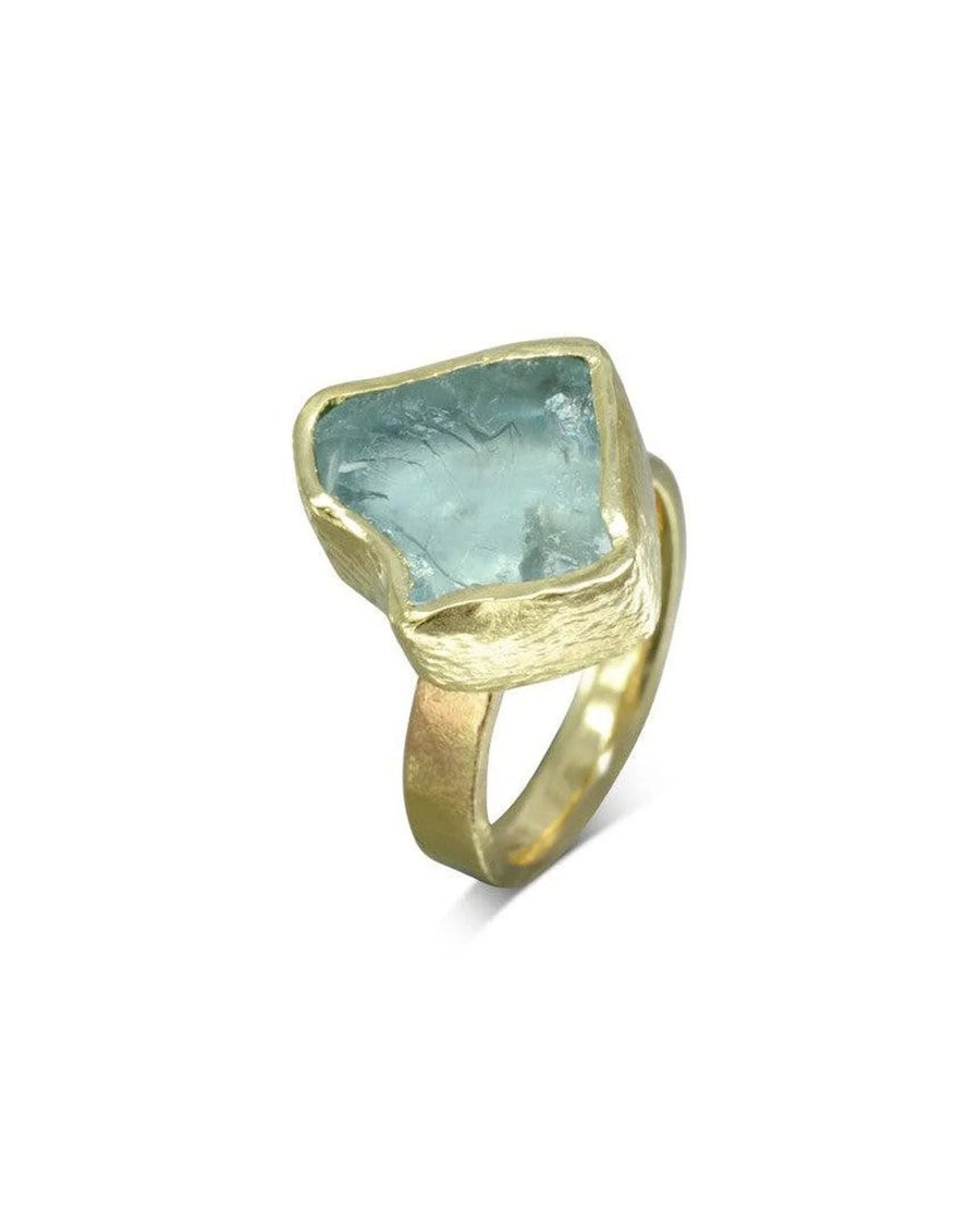 Raw aquamarine gemstone set in a textured yellow gold chunky dress ring