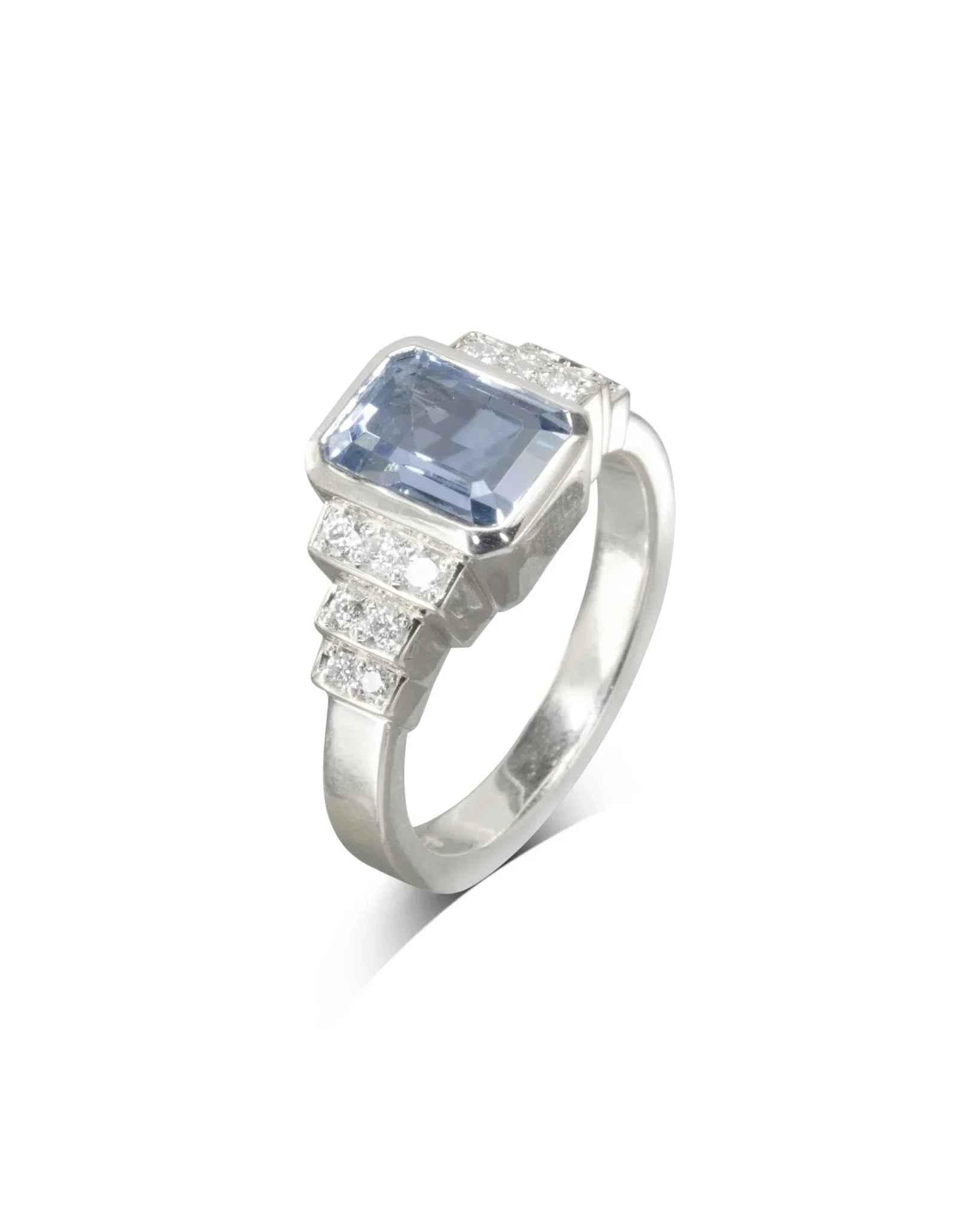 Art deco inspired engagement ring with emerald-cut aquamarine and diamond accents