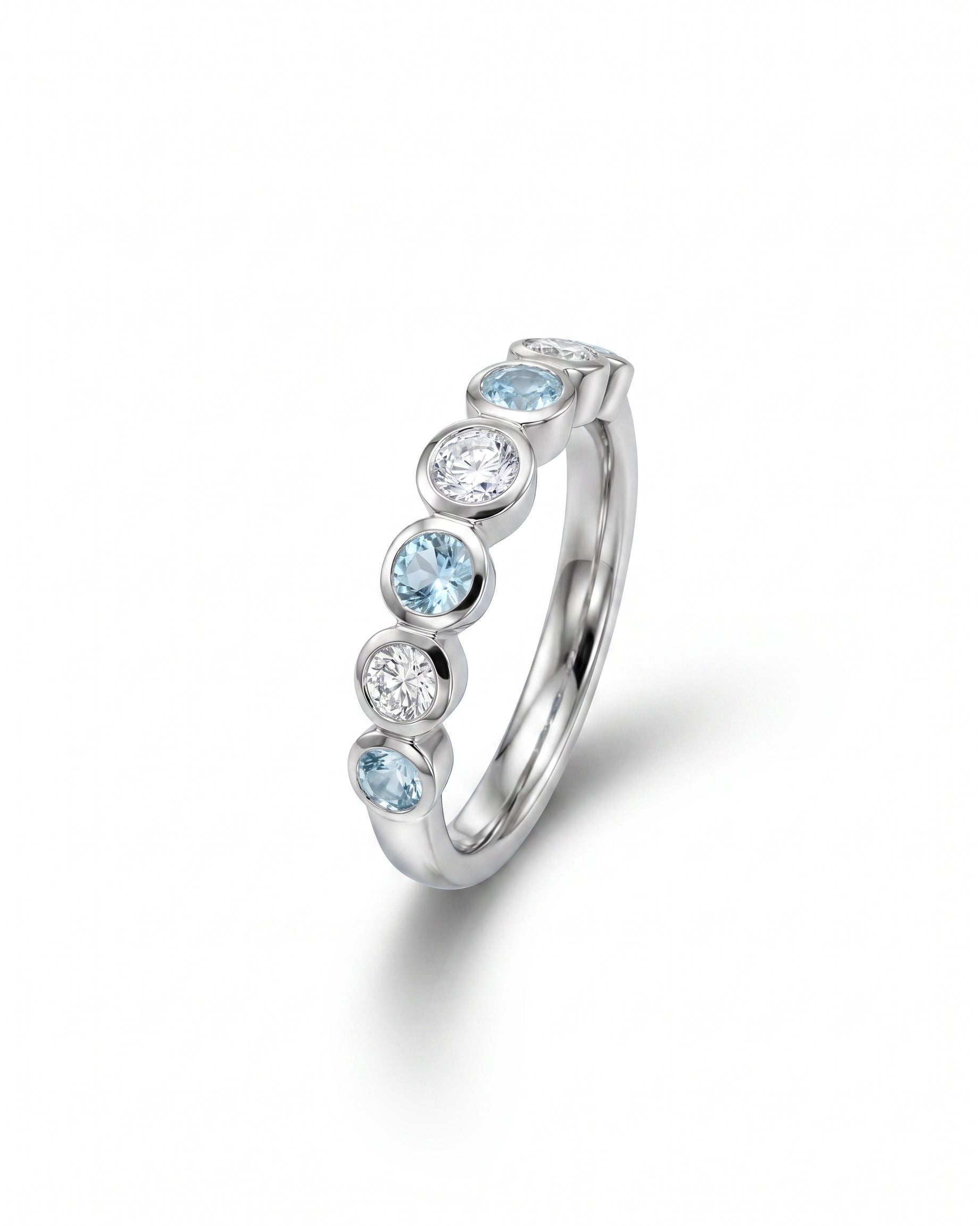 Platinum eternity ring with alternating aquamarine and diamond gemstones.
