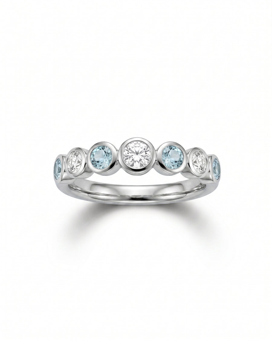 Platinum eternity ring with alternating aquamarine and diamond gemstones.