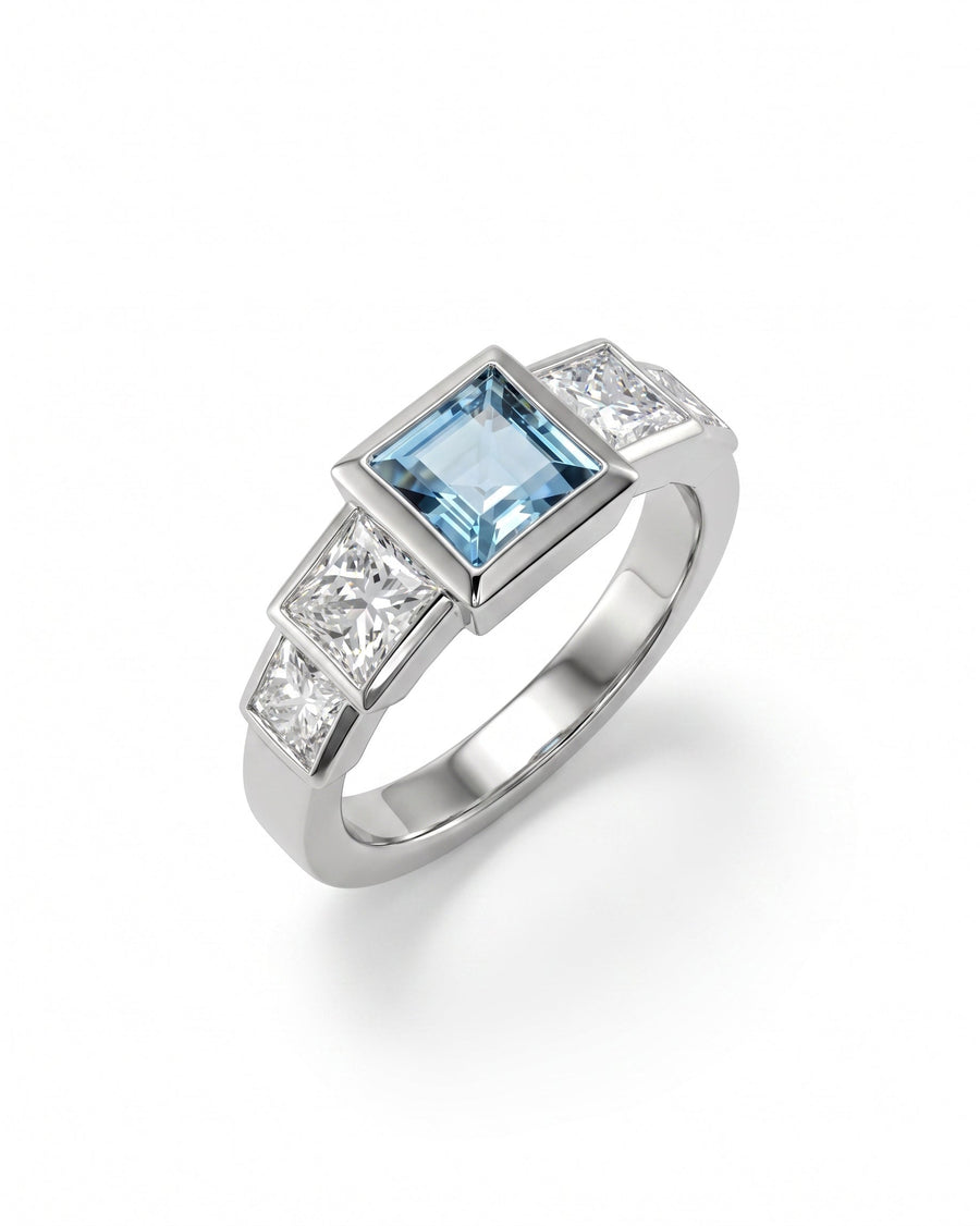 Silver Art Deco engagement ring with a square aquamarine and two princess-cut diamonds.