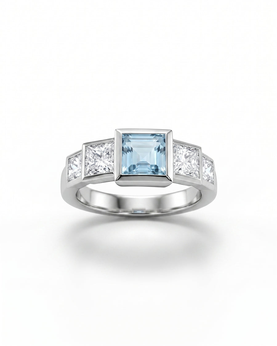 Platinum Art Deco engagement ring with a rectangular aquamarine and four princess-cut diamonds.