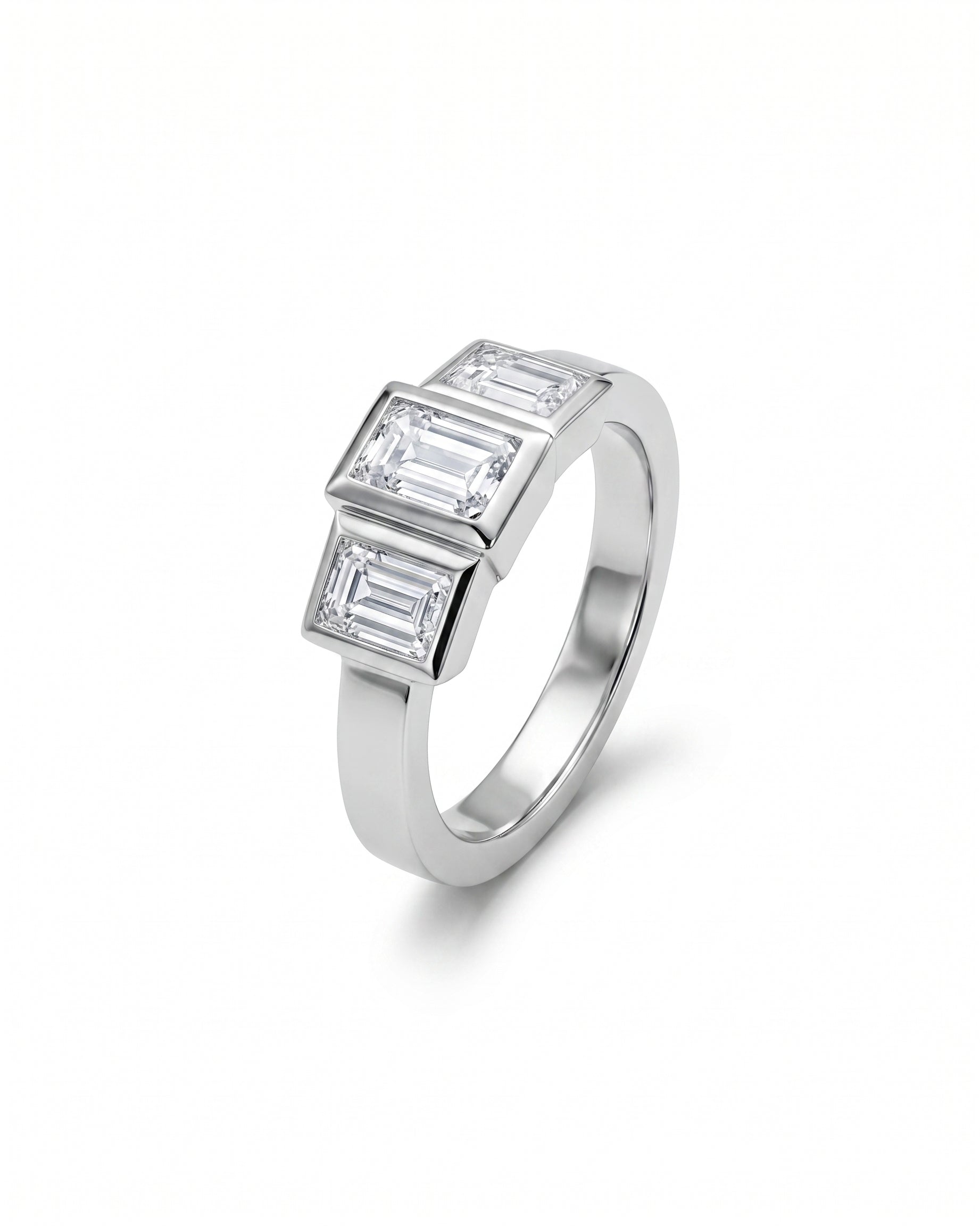 White gold ring with three emerald cut diamonds.