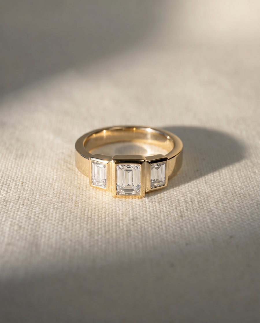18ct yellow gold ring with three emerald cut diamonds.