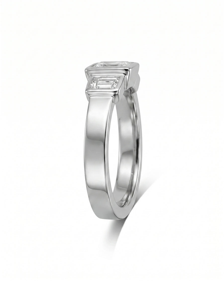 White gold ring with three emerald cut diamonds.