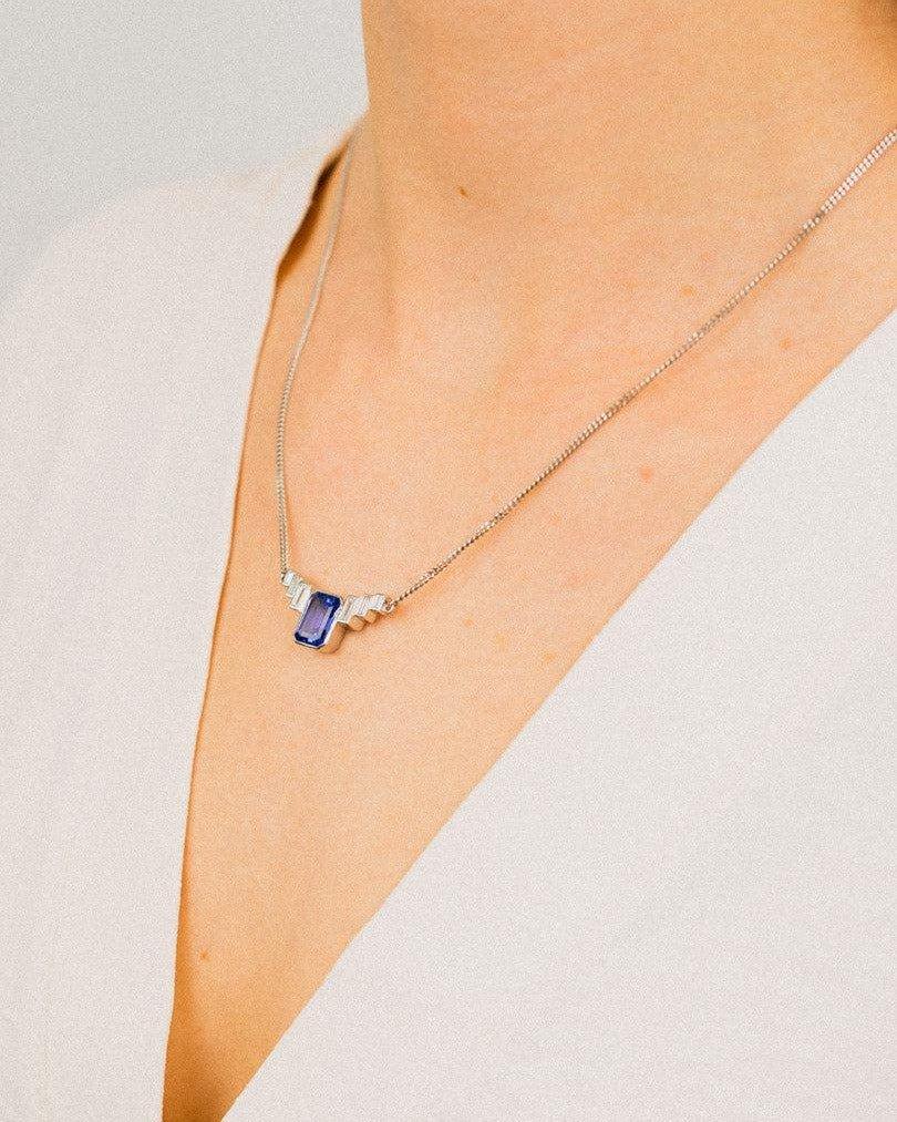 Art deco platinum necklace with blue aquamarine pendant and geometric diamond accents