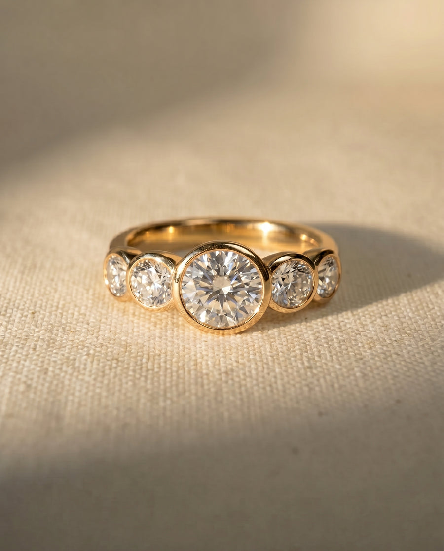 18ct yellow gold engagement ring with five round brilliant cut diamonds.