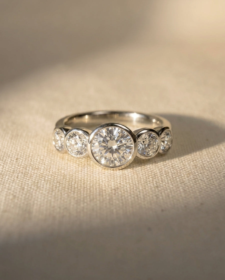 Platinum engagement ring with five round brilliant cut diamonds.