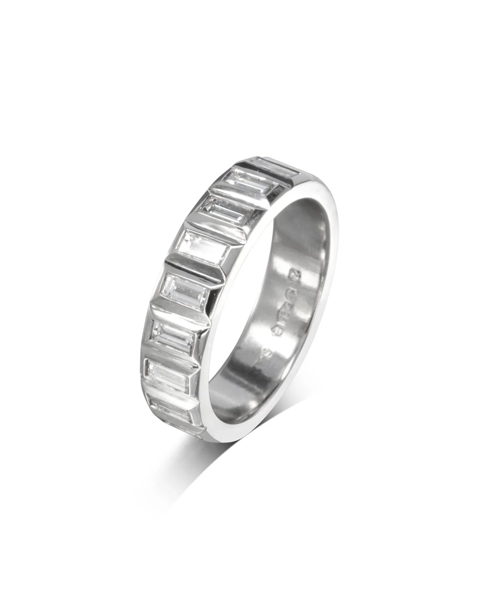 Platinum eternity ring with baguette-cut diamonds on white background