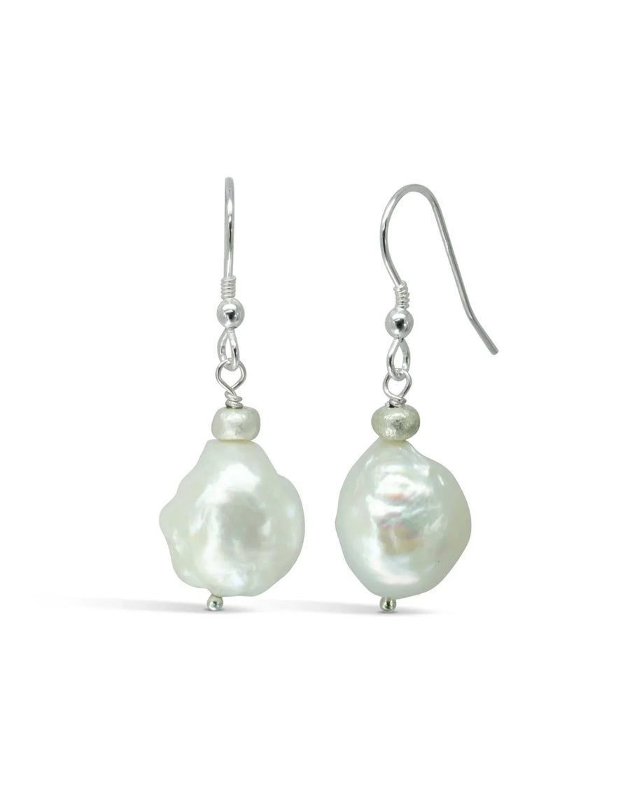 White baroque pearl drop earrings with silver hooks and small silver bead accents.