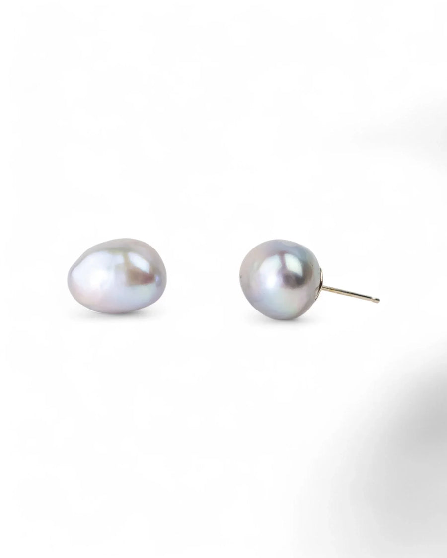 Two grey baroque pearl stud earrings with gold posts.
