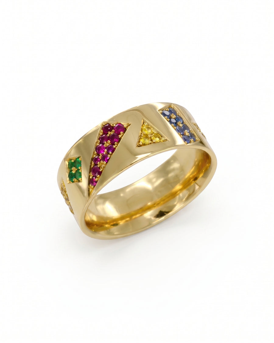 Gold eternity ring with geometric ruby, sapphire, and emerald gemstones.