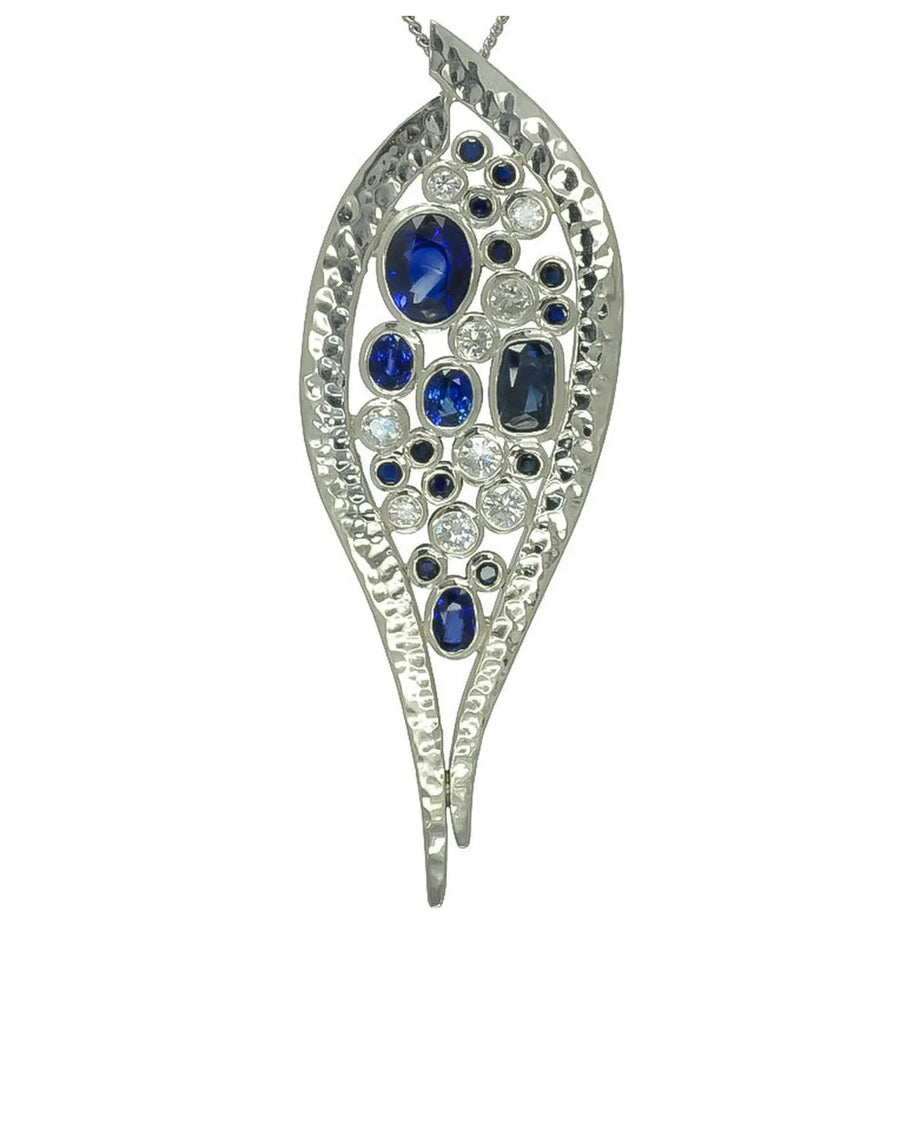 platinum pendant with blue sapphires and diamonds in textured leaf design
