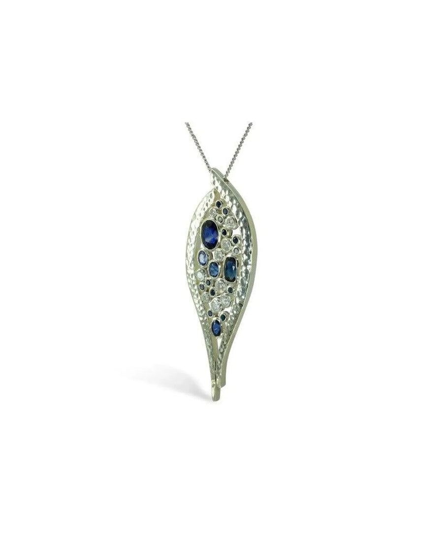 Handcrafted platinum pendant with blue sapphires and diamonds in an organic leaf shape