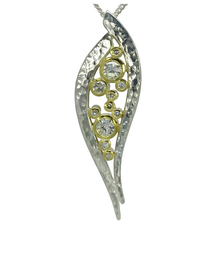 Handcrafted silver and gold pendant with diamonds and organic hammered texture