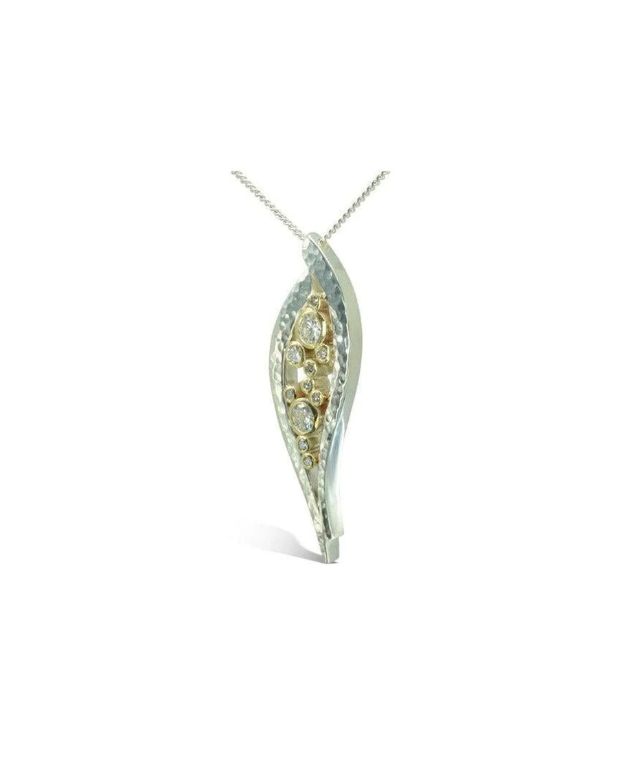 organic-shaped silver and gold diamond pendant with hammered texture on a chain