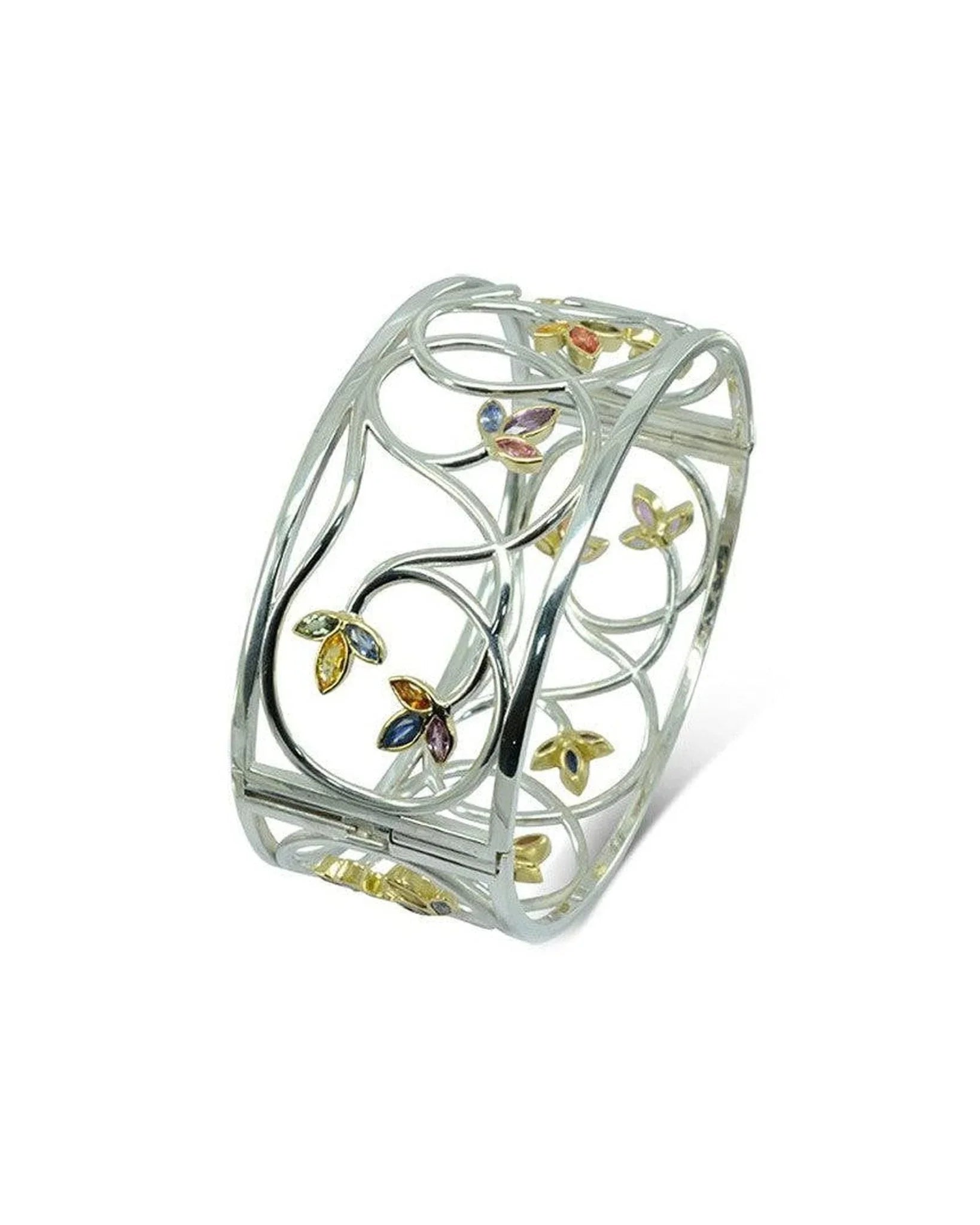 Handcrafted gold bangle with sapphire accents in an openwork floral design