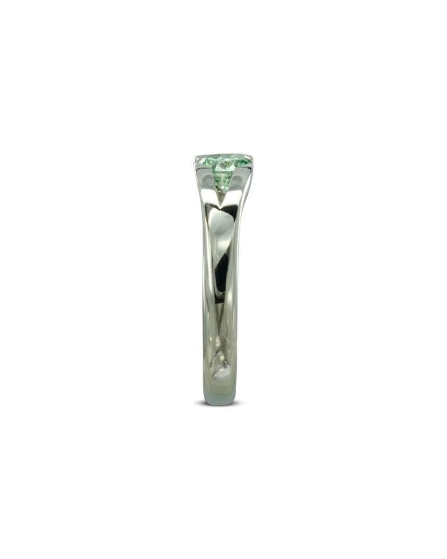 Platinum engagement ring with a round green diamond.