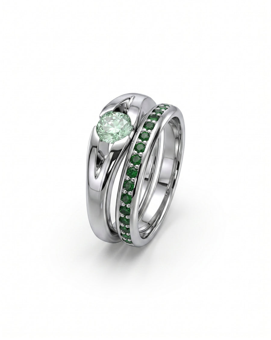 Platinum engagement ring with a round green diamond and a matching band with green diamonds.