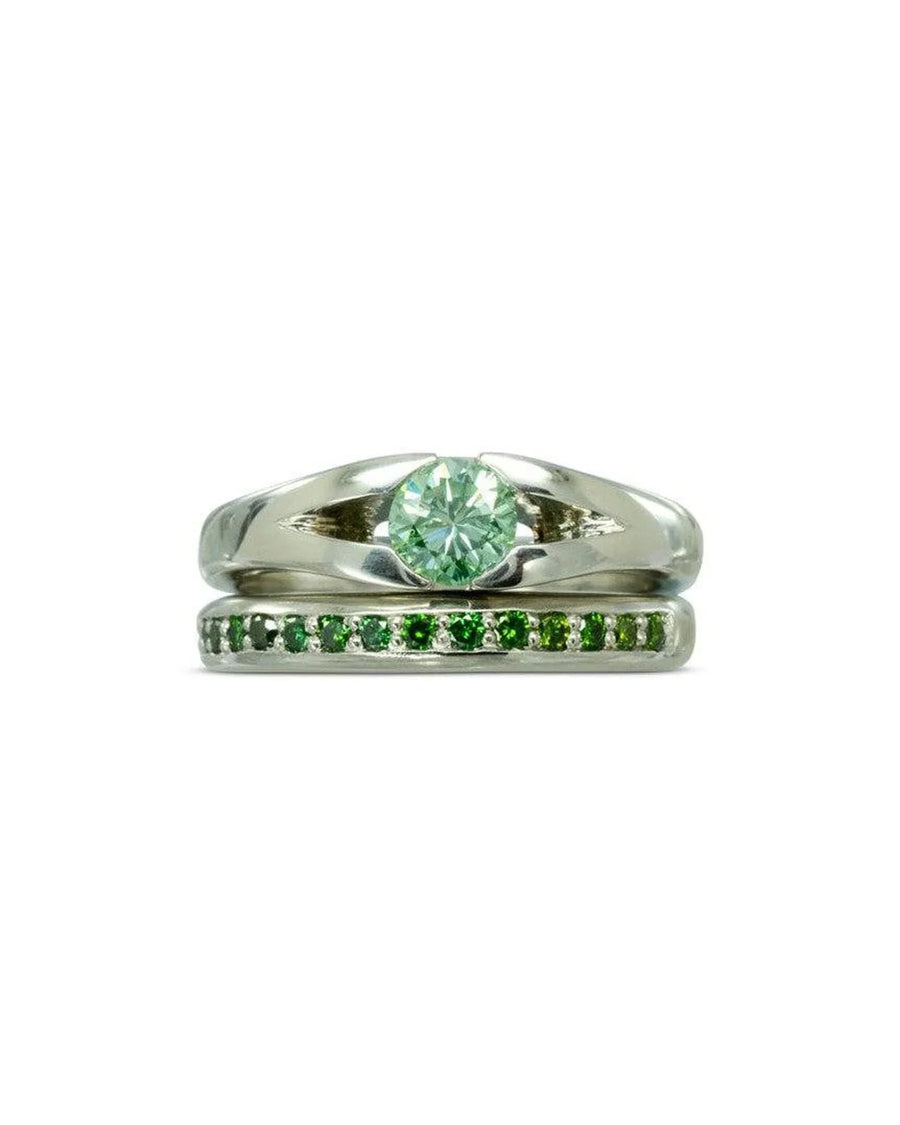 Platinum engagement ring with a round green diamond and a matching green diamond band.