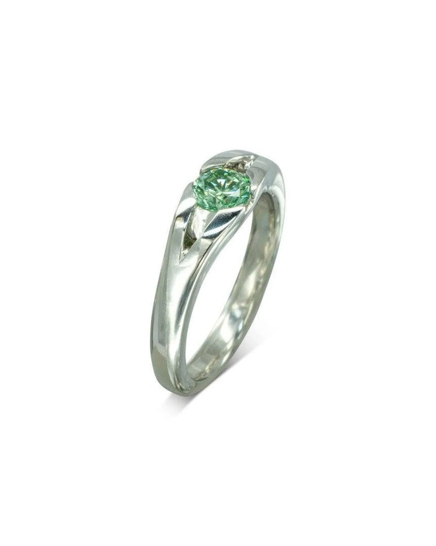Platinum engagement ring with a round green diamond.