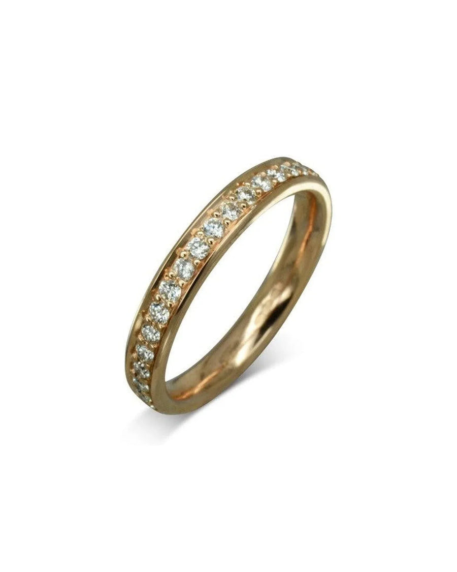 rose gold wedding ring with pavé set diamonds on white background