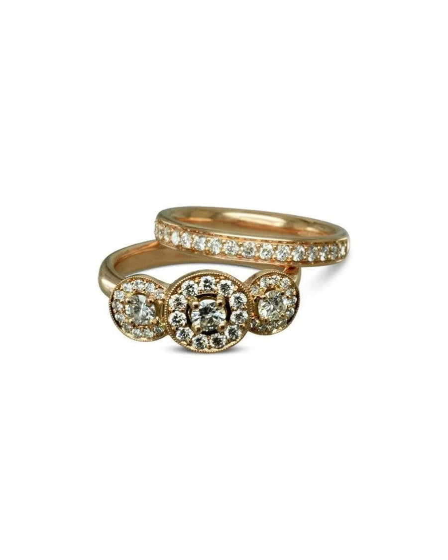 Rose gold diamond wedding ring set with three halo clusters and pavé band