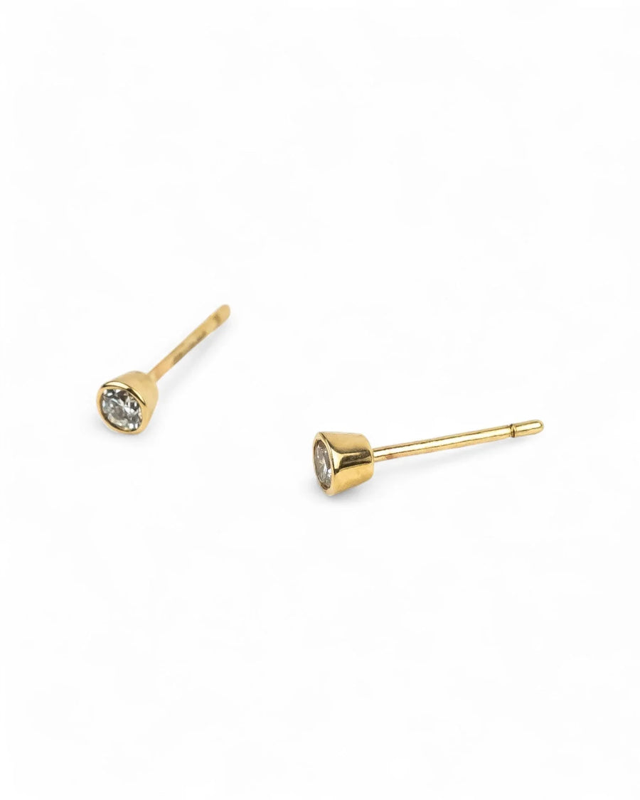 Gold bezel set diamond stud earrings.