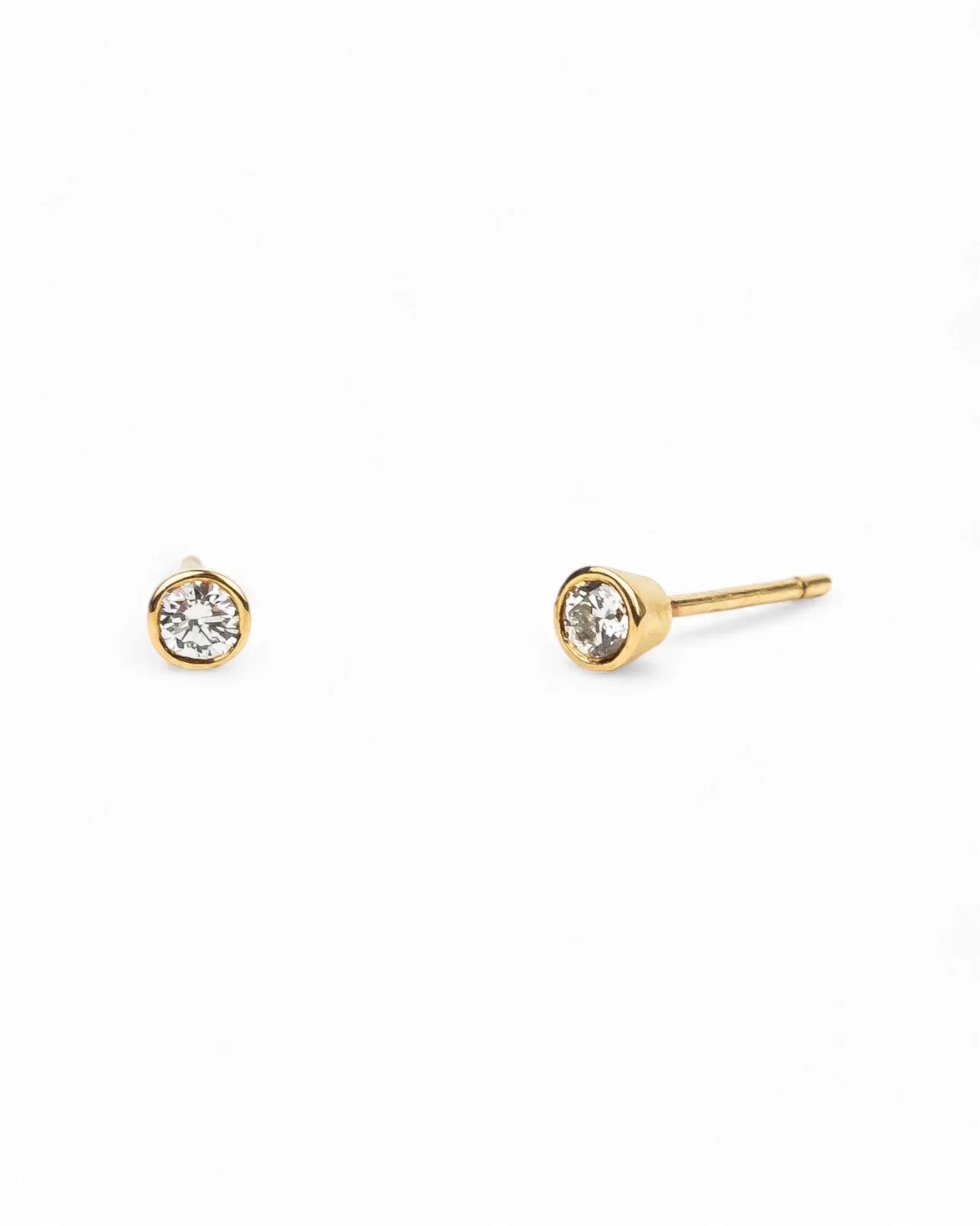 9ct yellow gold bezel set diamond stud earrings.