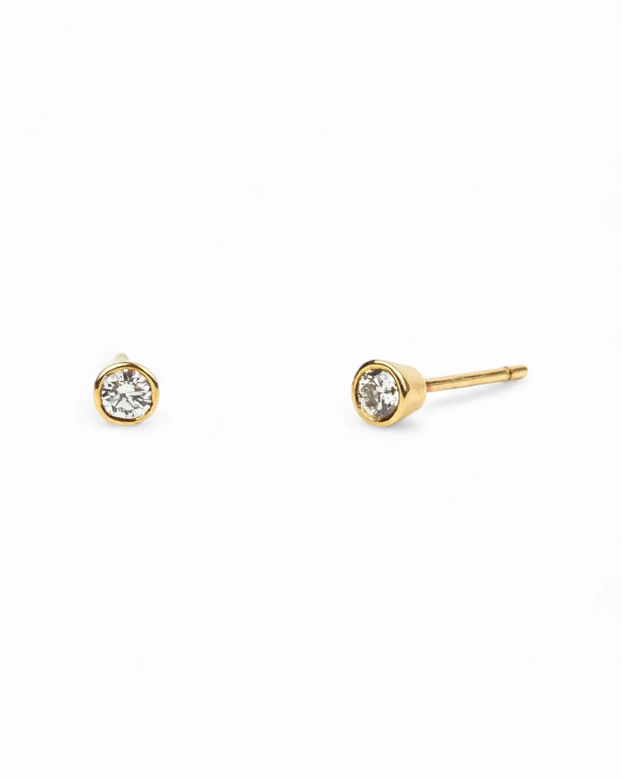 9ct yellow gold bezel set diamond stud earrings.