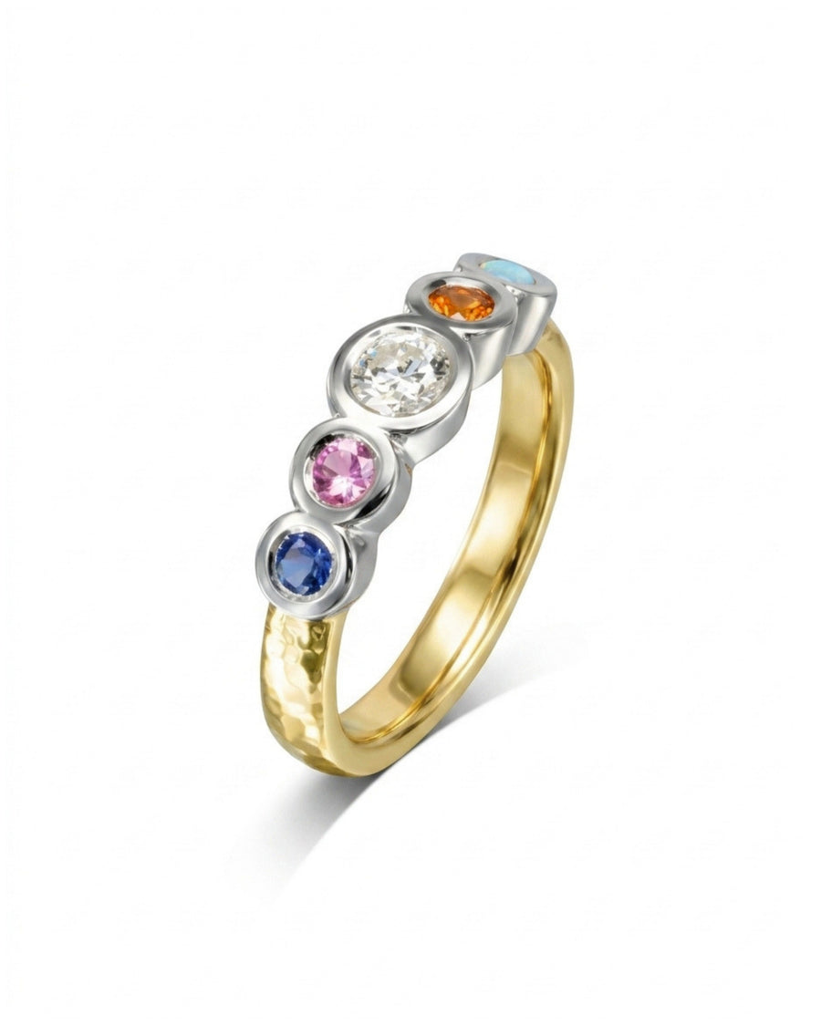 Gold and silver eternity ring with five colorful birthstones.