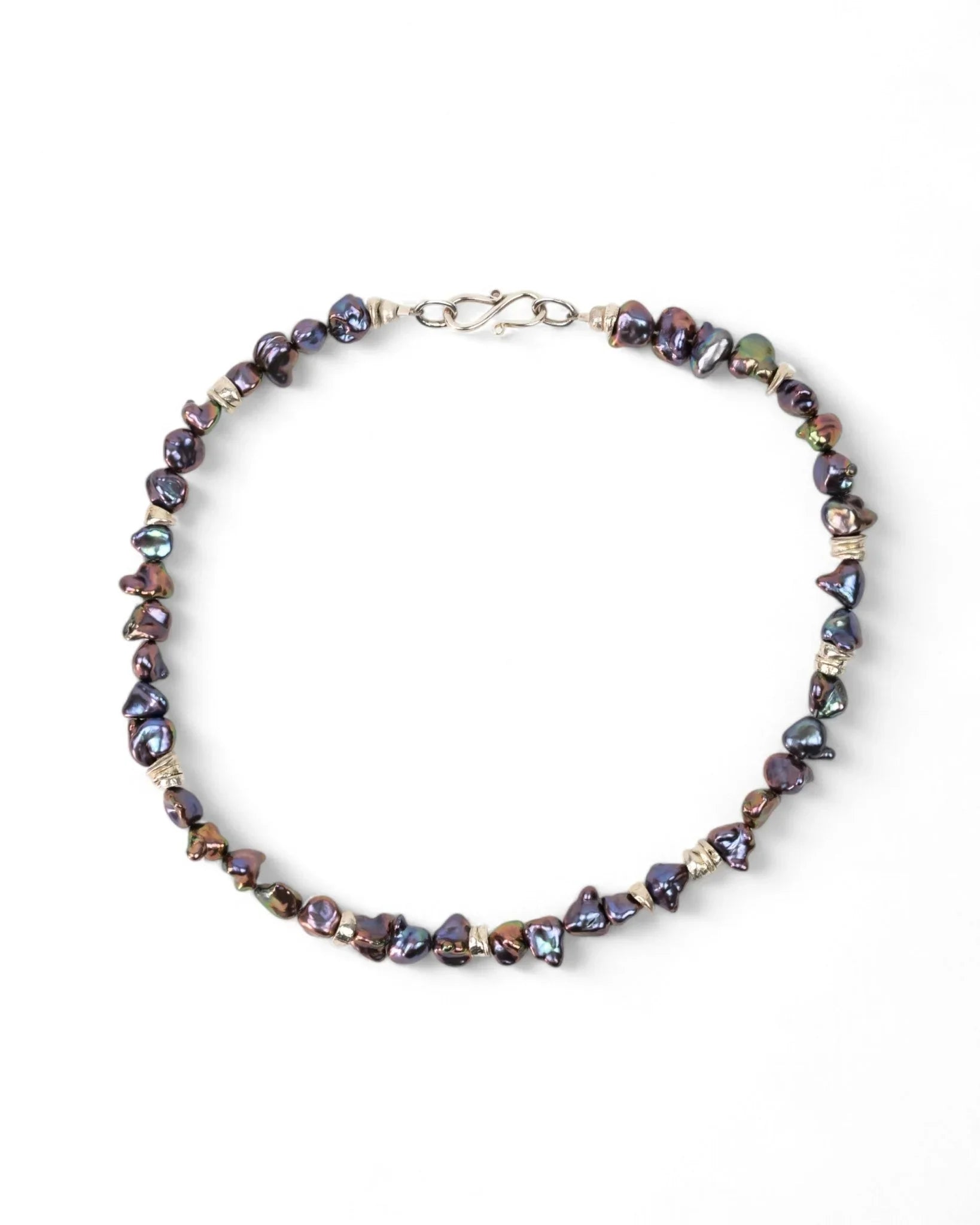 Handmade black keshi pearl necklace with organic shapes and silver clasp on white background