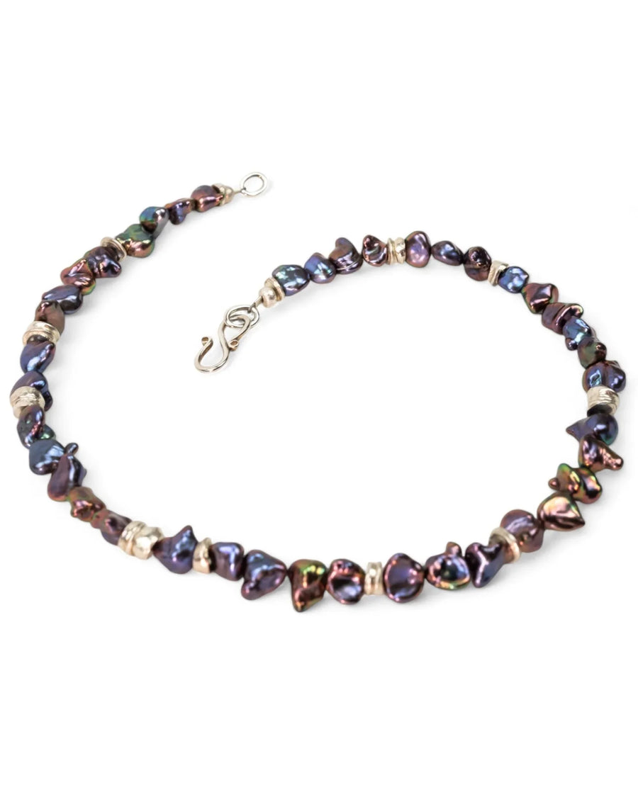 Black keshi pearl necklace with gold accents and organic, irregular shaped pearls