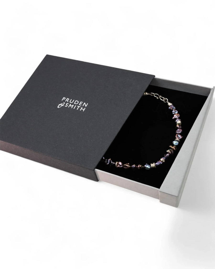 Black keshi pearl necklace with irregular organic pearls in a luxury gift box