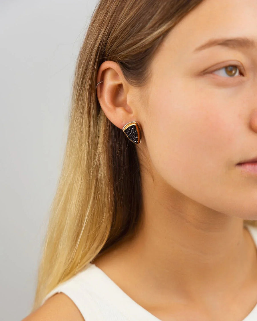 Black onyx druzy stud earrings with a gold-toned setting.