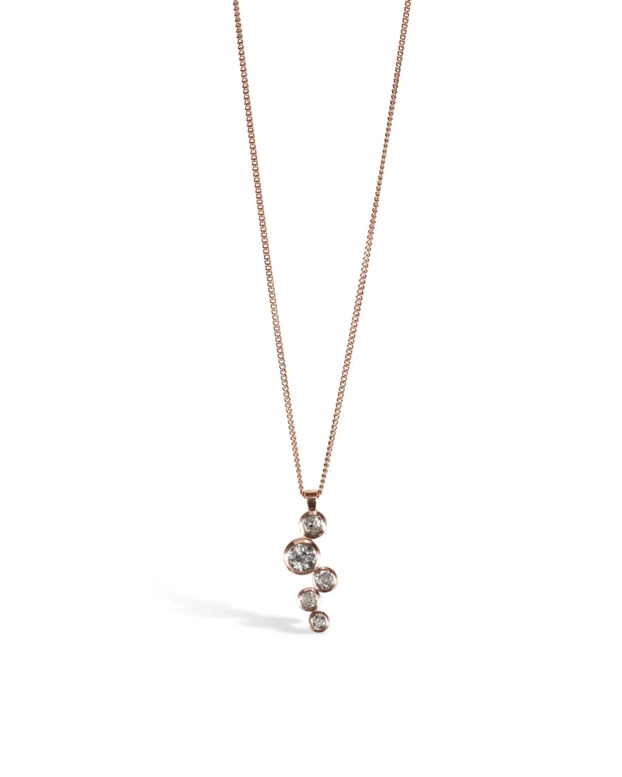 Rose gold necklace with round diamond bubbles pendant on a white background