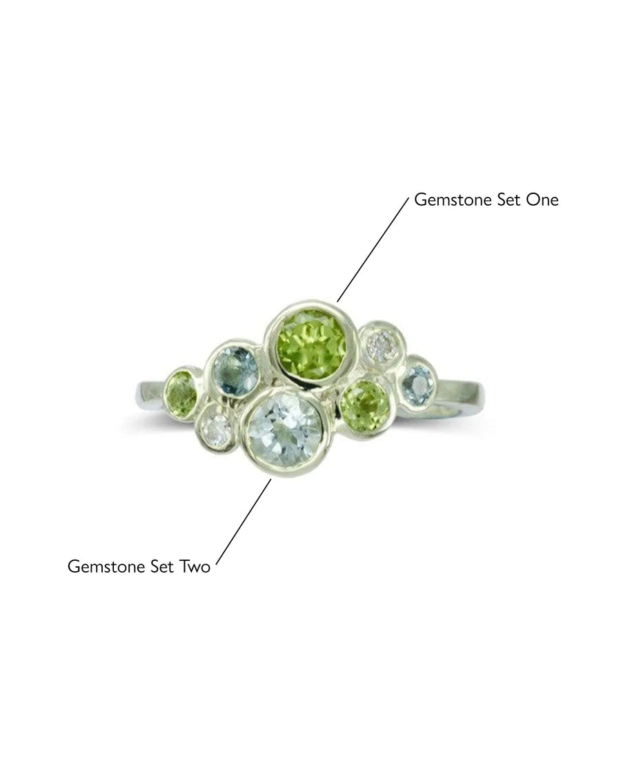 Handmade silver ring with clusters of green and blue gemstones in organic, unique design