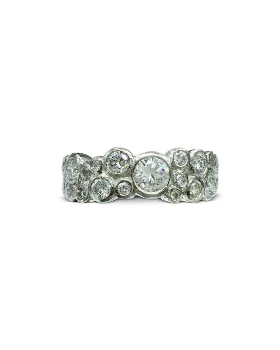 Silver eternity ring with various sized round diamonds in a bubble design.