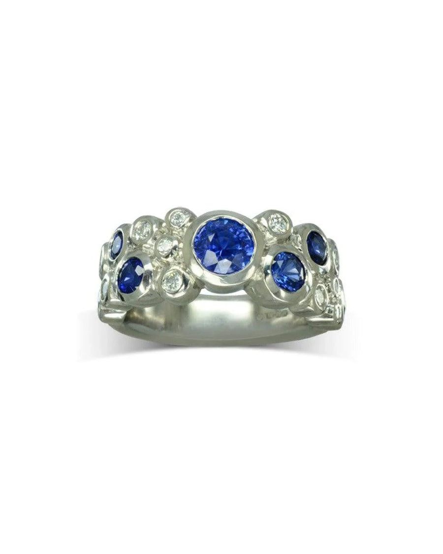 White gold eternity ring with oval and round blue sapphires and diamonds.