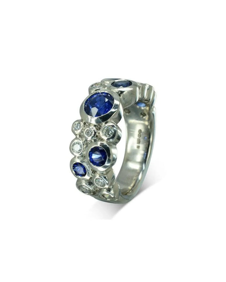 White gold eternity ring with blue sapphires and diamonds in a bubble design.