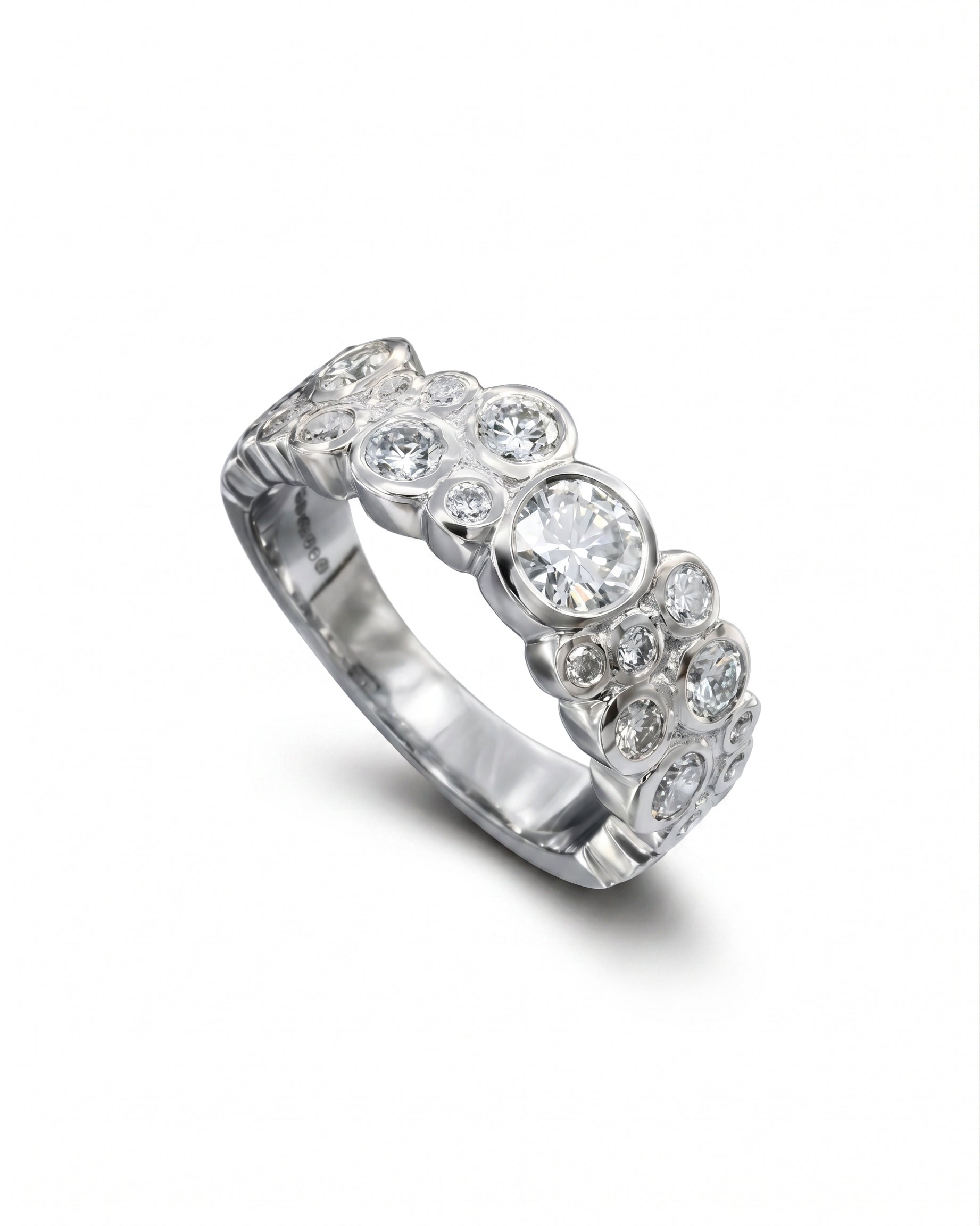 Platinum eternity ring with various sized laboratory grown diamonds.