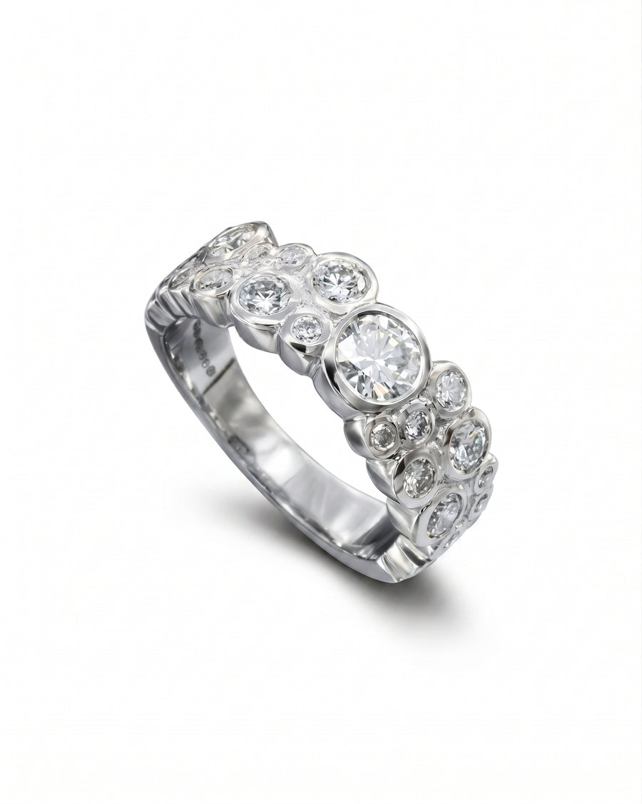 Platinum eternity ring with various sized laboratory grown diamonds.