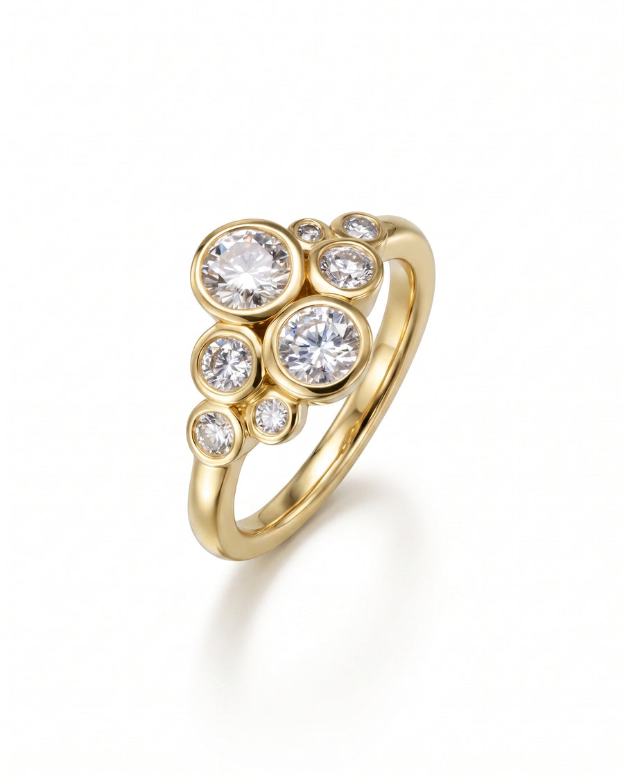 Gold ring with a cluster of bezel-set round diamonds.