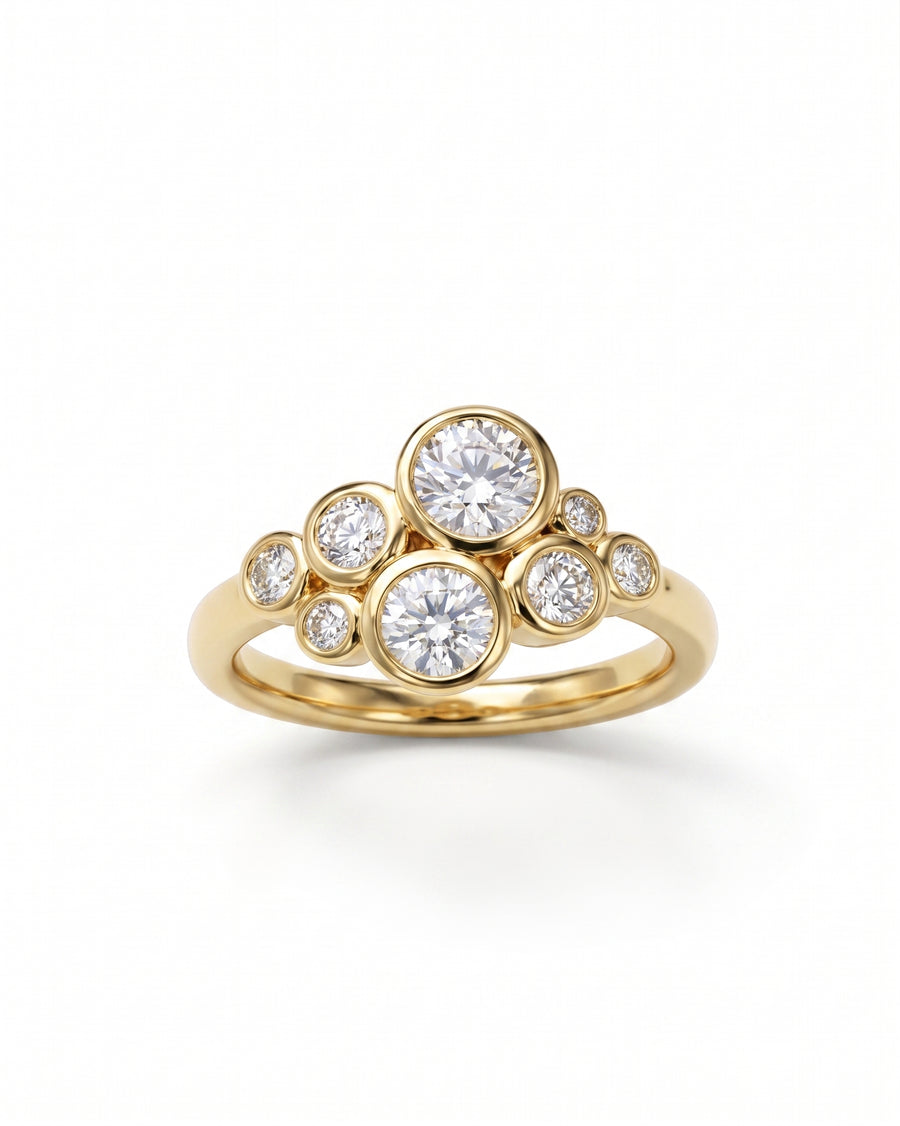 Gold ring with a cluster of bezel-set round diamonds.