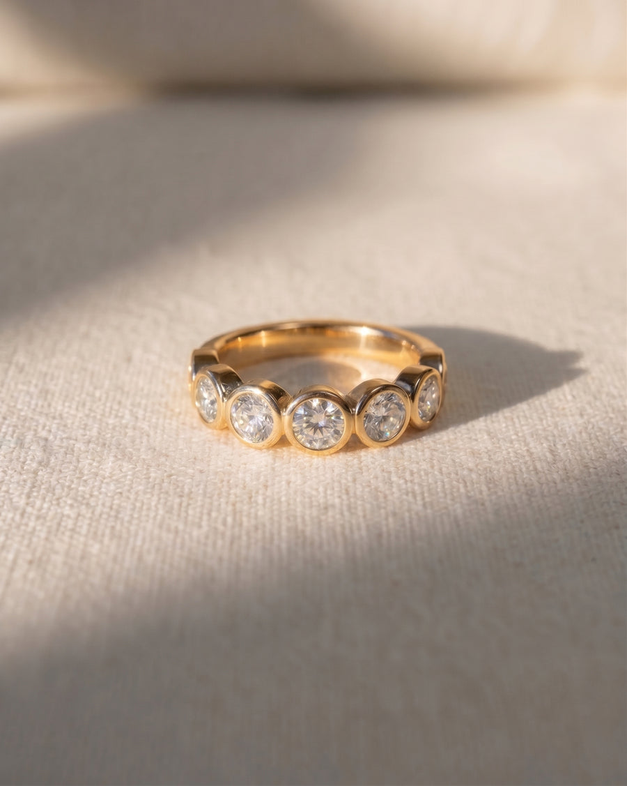 18ct yellow gold half eternity ring with round diamonds.