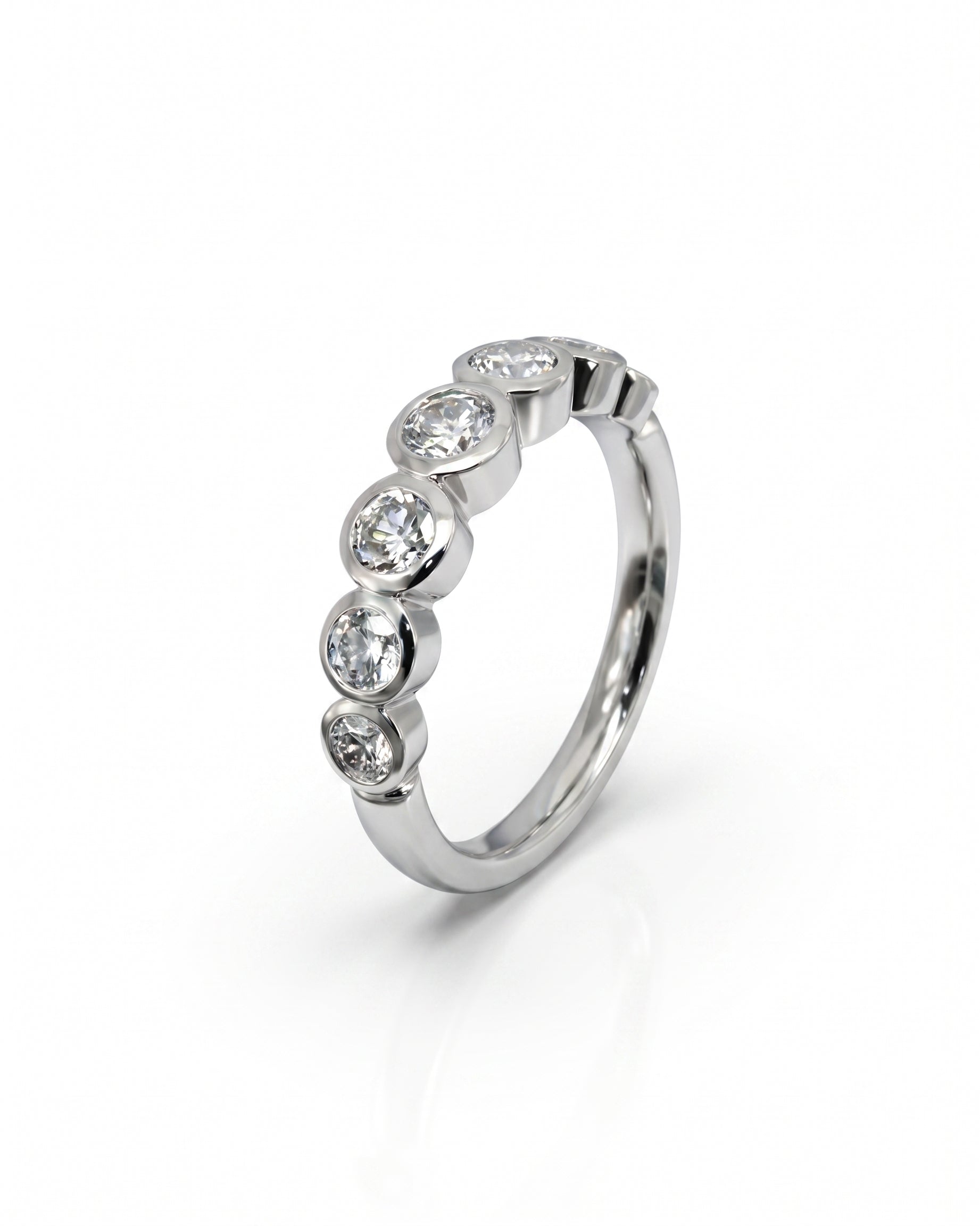 Silver half eternity ring with five bezel-set round diamonds.